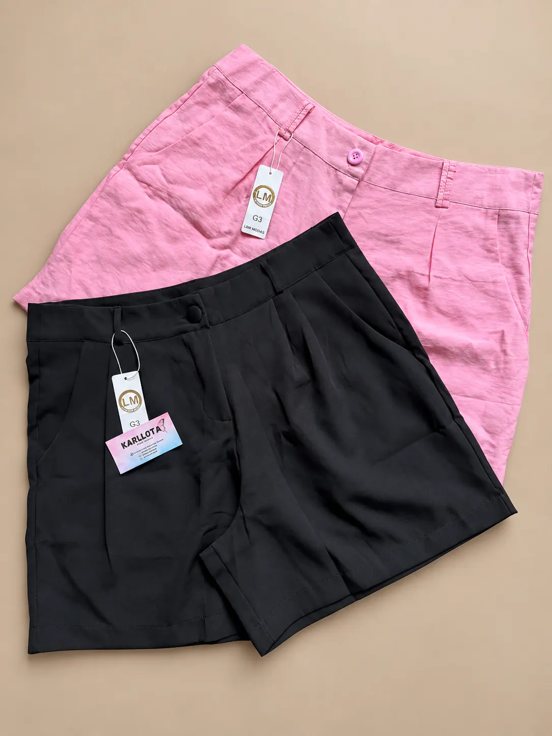 Shorts alfaiataria Plus nas cores rosa e preta.